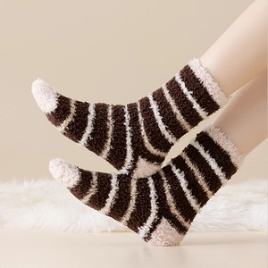 Adult winter warm coral fleece socks with striped pattern on white plush carpet