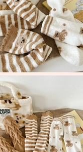 Detail of coral fleece socks with bear patterns and a cozy plush tote bag set