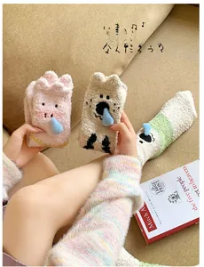 Detailed view of thick coral fleece winter socks with 3D cartoon animal decorations