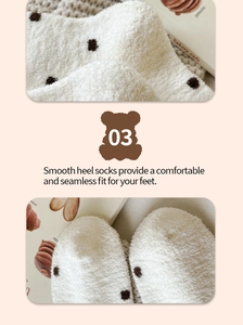 Detail view of plush coral fleece white socks with brown polka dots and smooth heel seam