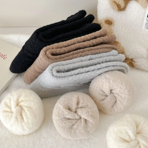 Thick warm plush socks in neutral colors with soft fluffy texture and folded design