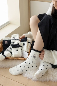 Detailed view of thick coral fleece socks with cute panda embroidery and warm winter texture