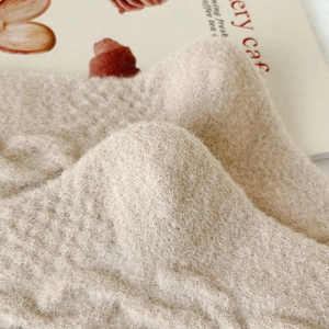 Close-up of beige fleece socks showing soft knit texture and warm thermal material