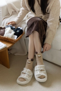 Detail of coral fleece socks with cute cartoon ears and thick plush fabric texture