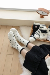 Detailed view of warm coral fleece socks featuring panda embroidery and lace trim design