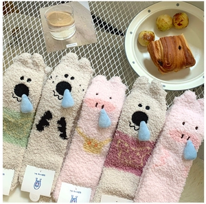 Close-up of five pairs of thick coral fleece warm socks with 3D cute cartoon details