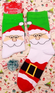 Women's Santa Claus holiday knit socks in red and green with festive tag detail