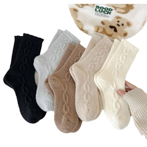 Five pairs of thick winter thermal socks for women in neutral knit cable patterns