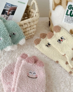 Detailed view of soft coral fleece socks with cute animal embroidery and wavy edges