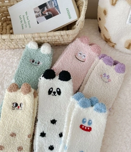 Detailed view of fluffy coral fleece socks with cute 3D animal ears and cozy texture