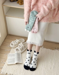 Close-up of soft coral fleece panda and polka dot warm mid-calf socks for women