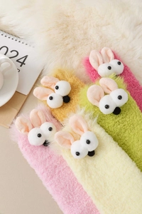 Close-up of cute plush bunny thermal socks in various colors with 3D ears and eyes