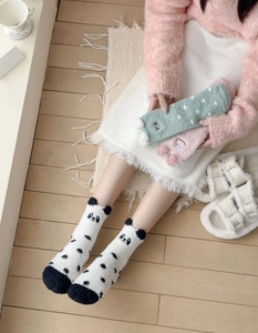 Close-up of thick coral fleece winter socks featuring cute cartoon animal designs