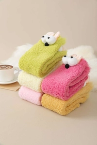 Close-up of five pairs of colorful plush coral fleece socks with 3D cartoon eyes and ears