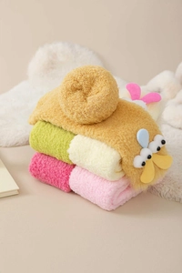 Detail of coral fleece thick warm socks with cute 3D duck cartoon character and soft texture