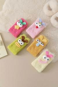 Detail of five colorful plush coral fleece headbands with cute cartoon 3D eyes and soft texture