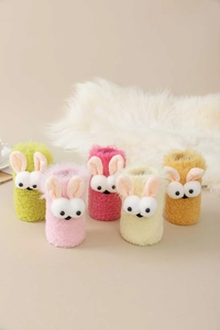 Detail of plush coral fleece socks featuring cute 3D bunny ears in five vibrant colors