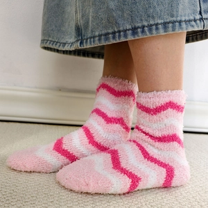 Detail of pink and white wavy coral fleece socks with a thick and soft fluffy texture