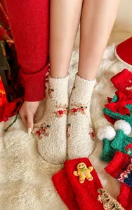 Detailed texture of thick Christmas coral fleece socks with cute reindeer embroidery