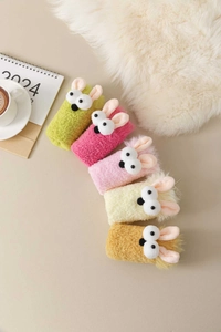 Detailed view of plush coral fleece rabbit socks in various pastel colors for winter comfort