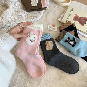 Detailed close-up of thick wool socks with cute 3D animal embroidery and ribbed cuffs