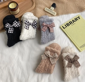 Detailed view of warm coral fleece socks with plaid bows in five neutral colors