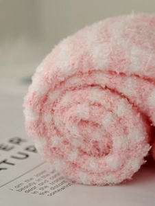 Macro shot of pink and white coral fleece socks showing soft texture and fluffy fabric