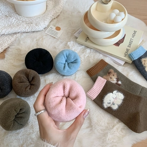 Detailed view of thick wool socks with inner fleece lining and cute 3D bear motif