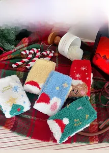 Collection de chaussettes de Noël en polaire corail sur une couverture à carreaux