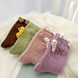 Set of four plush cartoon animal thermal socks with 3D ears on a white fur background