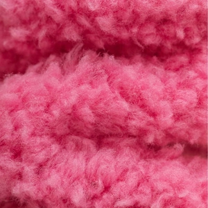Close-up of pink coral fleece socks showing soft plush texture and warm fuzzy material