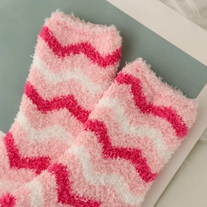 Close-up of pink and white wave pattern coral fleece thermal socks with plush texture