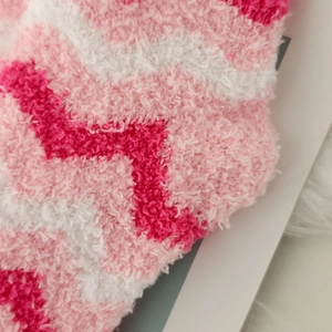 Macro detail of soft coral fleece texture with pink and white wave pattern