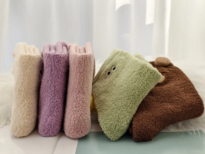 Detail of five pairs of thick thermal coral fleece socks with cute cartoon embroidery
