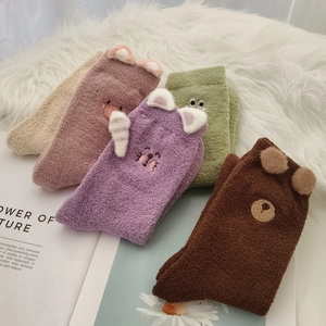Detail of four thick coral fleece socks with 3D ears and cute animal embroidery
