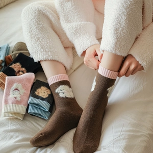 Detail of warm wool socks with cartoon dog jacquard and ribbed cuffs in various colors