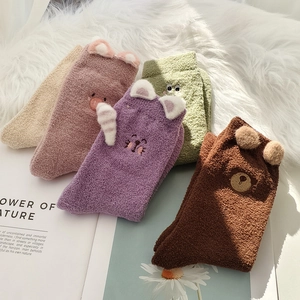 Detailed view of colorful cartoon animal thermal socks in thick coral fleece material