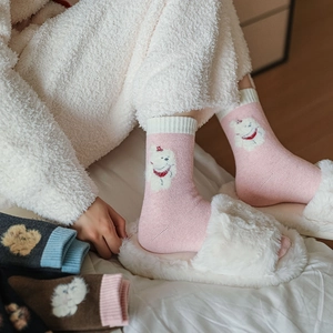 Close-up of thick thermal wool socks with cute cartoon 3D animal patterns for winter