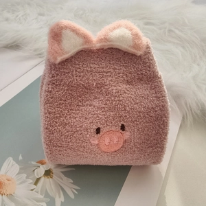 Close-up of pink coral fleece socks featuring a cute 3D cartoon pig embroidery design