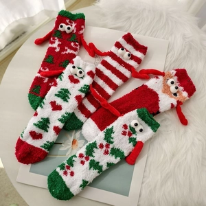 Set of four plush coral fleece Christmas socks featuring cartoon eyes and 3D magnetic hands