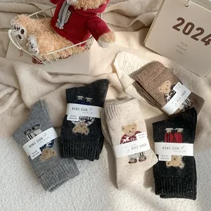 Detail of wool blend socks with cute bear embroidery in five warm winter colors