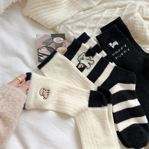 Detail of warm fluffy thermal socks featuring cute puppy embroidery and soft knit texture