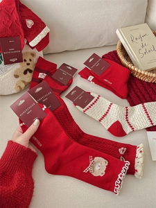 Detail view of festive red and cream socks featuring bow knots and heart patterns