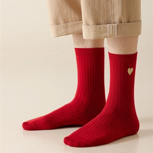 Red mid-calf ribbed socks featuring a delicate gold heart embroidery on the side