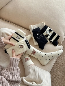 Detail of warm winter socks with cute cartoon puppy embroidery and soft plush fabric texture