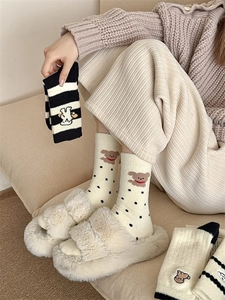 Detail showing thick winter thermal socks with cute bear embroidery and ribbed cuffs