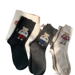 Three pairs of vintage knit crew socks with bear jacquard and colorful tweed texture