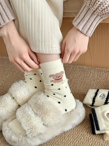 Close-up of thick thermal fleece socks featuring cute bear embroidery and polka dot patterns
