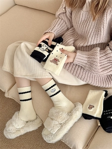 Close-up of thick winter thermal socks with cute animal embroidery and stripe patterns