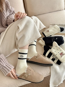 Close-up of soft thick socks with cute puppy embroidery and stripe patterns